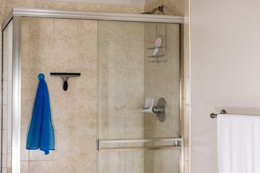 Keep a squeegee in the shower to keep build-up to a minimum.